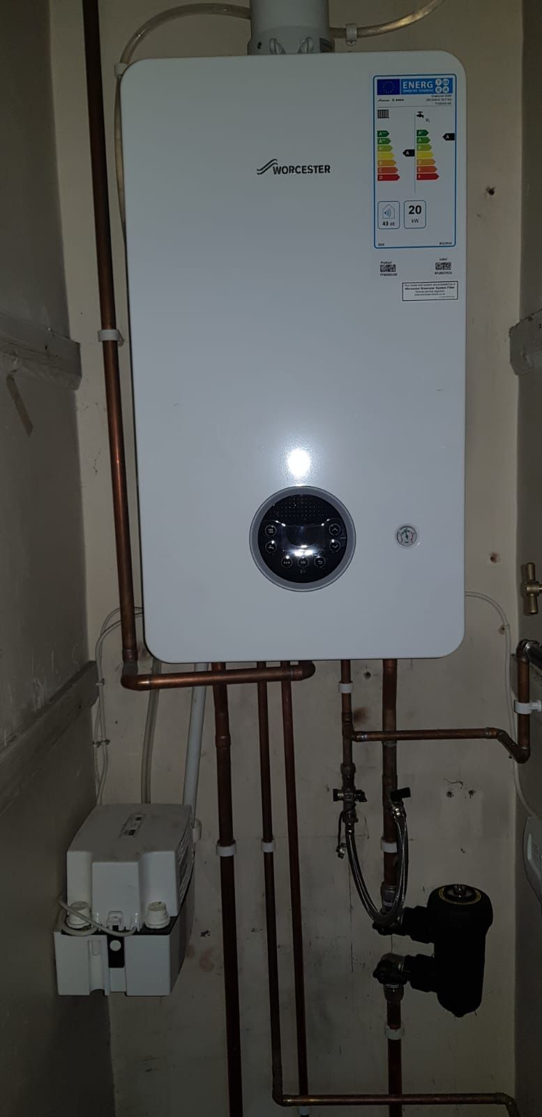 Gas pipework and condensate pump neatly installed below a wall-mounted Worcester boiler